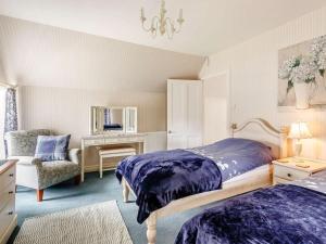 a bedroom with a bed and a chair and a desk at 4 Bed in Pitlochry oc-ca274 in Foss