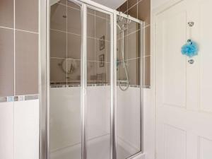 a shower with a glass door in a bathroom at 4 Bed in Pitlochry oc-ca274 in Foss +23 photos