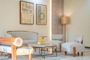 a living room with two chairs and a table at Shlaka Farms in Jaipur