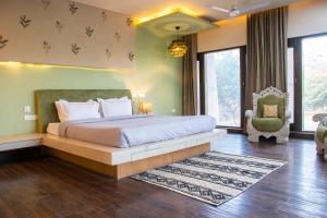 a bedroom with a large bed and a green wall at Shlaka Farms in Jaipur +50 photos