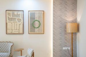 a living room with two pictures on the wall at Shlaka Farms in Jaipur