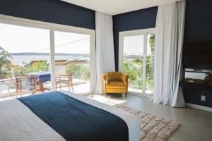 a bedroom with a bed and a view of the ocean at The View Pipa in Pipa