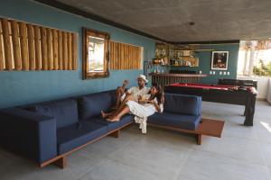 a man and two girls sitting on a blue couch at The View Pipa in Pipa