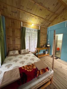 a bedroom with a bed in a wooden room at Verde Guest House in Shillong