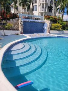 a swimming pool with steps in the water at Mar Paraiso in Ocho Rios