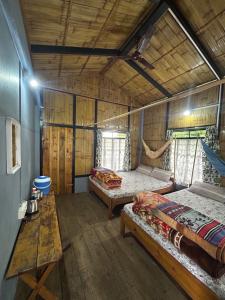 a room with two beds and a hammock in it at Verde Guest House in Shillong +22 photos