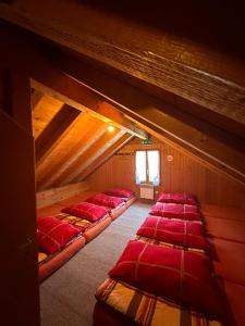 a group of four beds in a room with a attic at Alpwirtschaft Heirihütte in Rigi Klösterli +5 photos