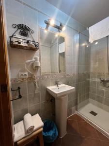a bathroom with a sink and a shower at Hostal Hueso in Trujillo +36 photos