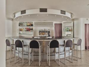 a bar with a table and chairs in a room at Toscana Ambassador in Poggibonsi