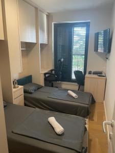 a room with two beds and a chair and a window at ToP-HILL in Trebinje +29 photos