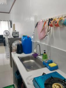 a kitchen with a sink and a counter top at Zoldyck Property in Pahanocoy