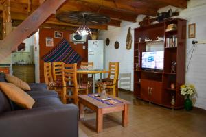 a living room with a couch and a table at Cabañas "La Quimera" in El Durazno
