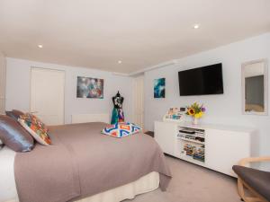 a bedroom with a bed and a tv on the wall at The Art Studio in Bath