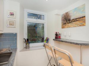 a kitchen with two chairs and a window at The Art Studio in Bath +5 photos