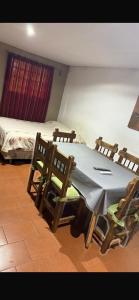 a room with a table and chairs and a bed at cris in Sierra de los Padres