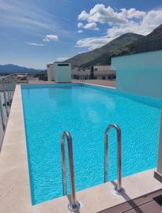 a large blue swimming pool on top of a building at ToP-HILL in Trebinje