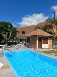 a swimming pool in front of a house at Pontal Tapes Hotel in Tapes +21 photos