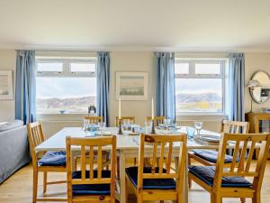 a dining room with a white table and chairs at 4 Bed in Scourie oc-ca399 in Scourie