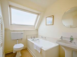 a white bathroom with a sink and a toilet at 4 Bed in Scourie oc-ca399 in Scourie