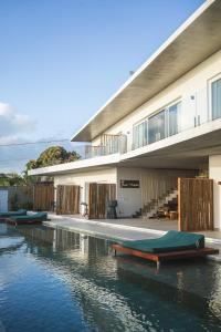 a house with a swimming pool next to the water at The View Pipa in Pipa