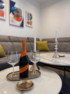 a bottle of wine and two glasses on a table at ToP-HILL in Trebinje