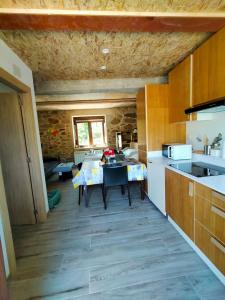 a kitchen with a table in the middle of it at Vía Láctea Costa da Morte in Dumbría +19 photos