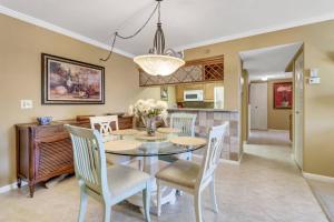a dining room with a table and chairs at Palm Beach Landings A107 in Fort Myers +37 photos