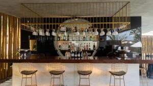 a bar with four chairs in a room at The View Pipa in Pipa