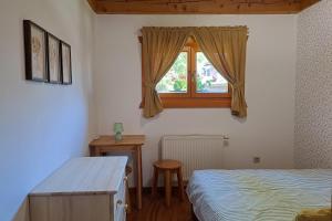 a bedroom with a bed and a window at Drevenica pod Lánom in Zuberec