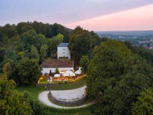 an aerial view of a white building on a hill at Sunday Hotel Bielefeld Johannisberg in Bielefeld +79 photos
