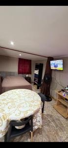 a bedroom with a bed and a flat screen tv at Toby in Sierra de los Padres