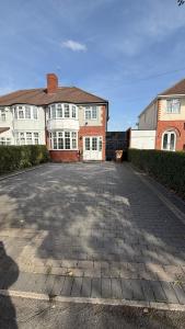 an empty parking lot in front of a house at Delves House in Bescot