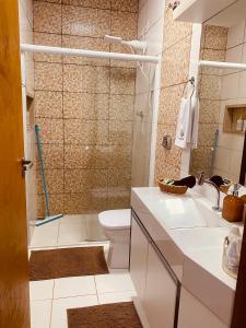a bathroom with a shower and a toilet and a sink at Casa Pires - Sinop MT in Sinop +52 photos