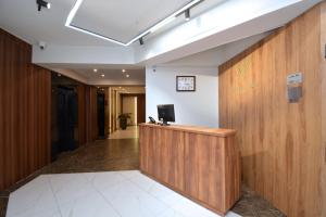 an office lobby with a desk with a television on it at Nord Gate Avenue Hotel in Yerevan