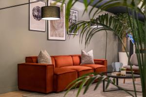 a living room with a couch and a table at Zedwell Underground Hotel Tottenham Court Rd in London +32 photos