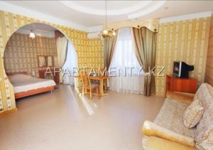 a bedroom with a bed and a couch in a room at Delight Сая in Astana