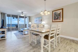 a dining room with a white table and chairs at Estero Island Beach Villas 105 in Fort Myers Beach