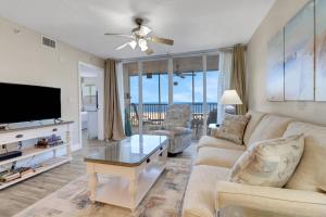 a living room with a couch and a tv at Estero Island Beach Villas 105 in Fort Myers Beach +27 photos