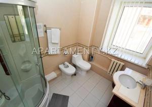 a bathroom with a shower and a toilet and a sink at Delight Сая in Astana