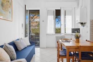 a living room with a blue couch and a table at Follonica Vacanze 7 in Follonica