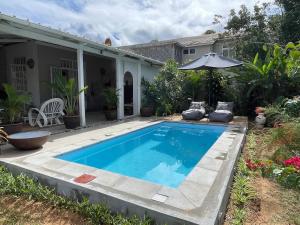 a swimming pool in the backyard of a house at Villa Evalia in Albion