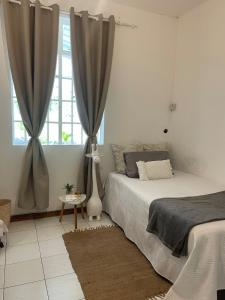 a bedroom with two beds and a window at Villa Evalia in Albion