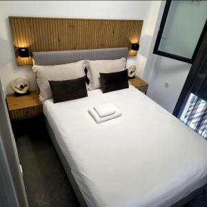 a bedroom with a large white bed with two pillows at Diamond Deluxe Loft in Iraklitsa +27 photos