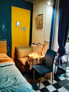 a bedroom with a bed and a chair and a table at le Cabanon Beldi in Rabat