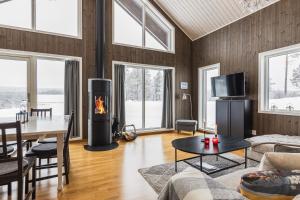 a living room with a fireplace and a table at Orrmötesvägen 21 - Funäsdalen in Funäsdalen