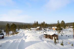 a snow covered village with a house and a road at Orrmötesvägen 21 - Funäsdalen in Funäsdalen +27 photos