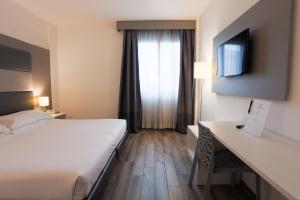 a hotel room with a bed and a desk at Toscana Ambassador in Poggibonsi +31 photos