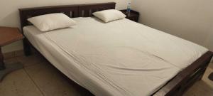 a large bed with two pillows on top of it at Matha homestay Vattavada in Vattavada