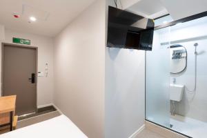 a bathroom with a shower and a toilet at KIMSTEL Jongno in Seoul +59 photos