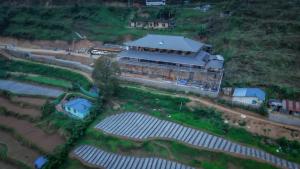 an aerial view of a building with solar panels at Matha homestay Vattavada in Vattavada +11 photos